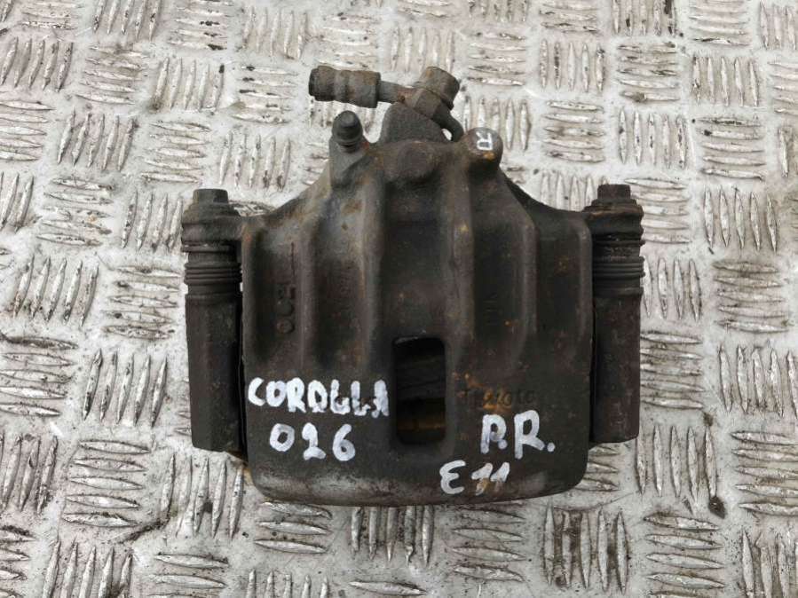 Суппорт передний левый к Toyota Corolla 1998