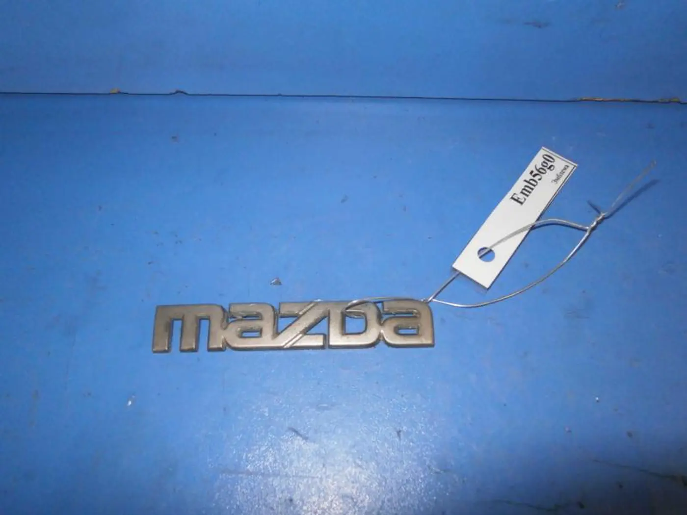 Эмблема к Mazda 323 1995