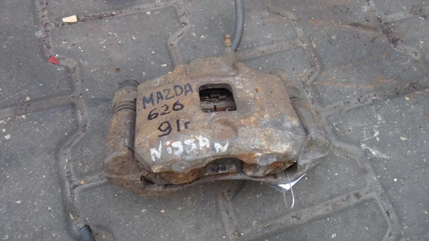 Суппорт передний левый к Mazda 626 1991