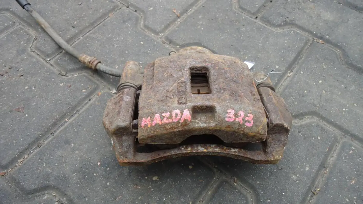 Суппорт передний правый к Mazda 323 1998