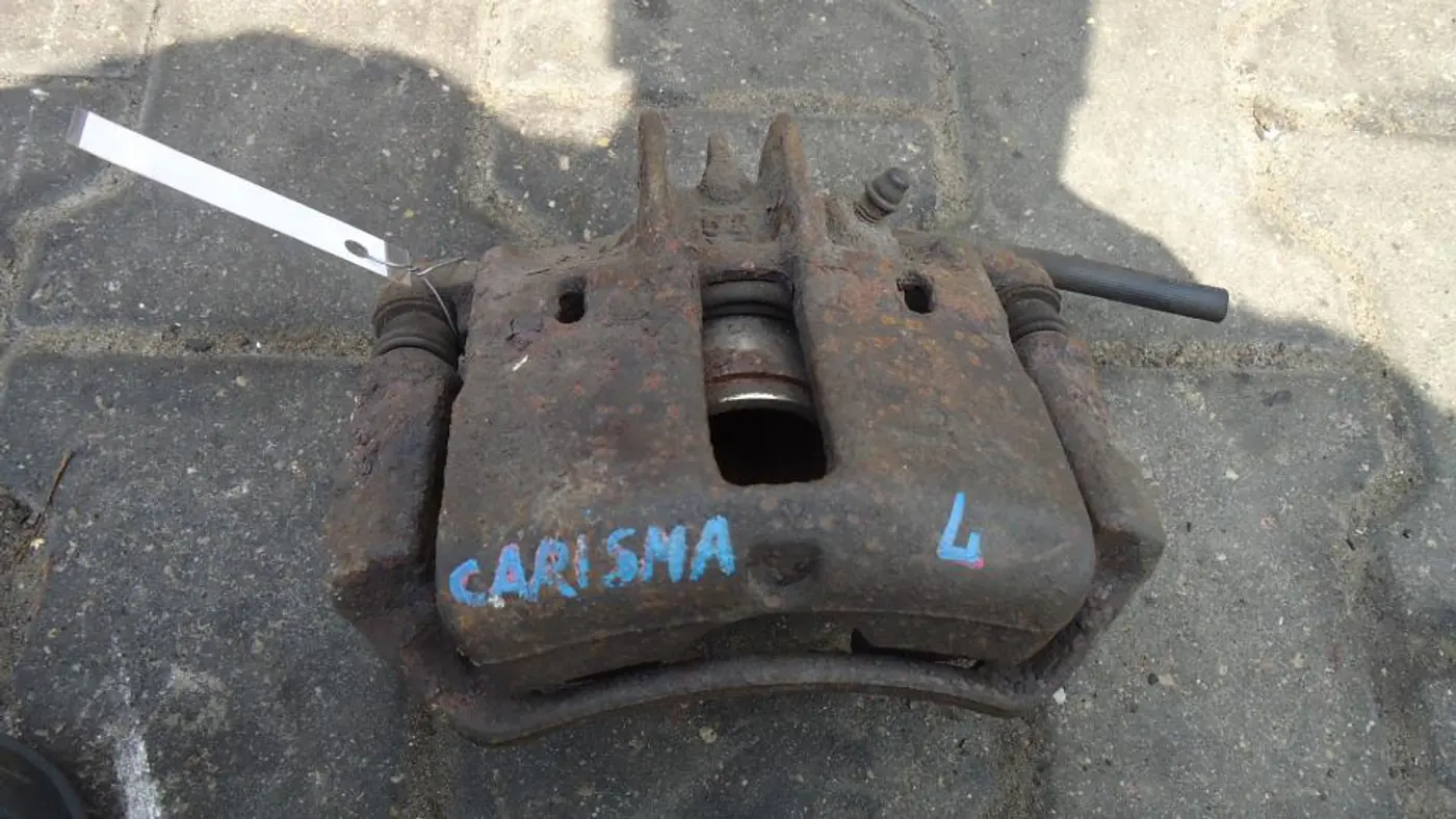 Суппорт передний левый к Mitsubishi Carisma 1997